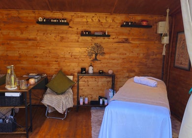Relaxing massage room at Saltwoods Healing & Massage, Herne Bay, England, GB, featuring a cozy wooden interior.