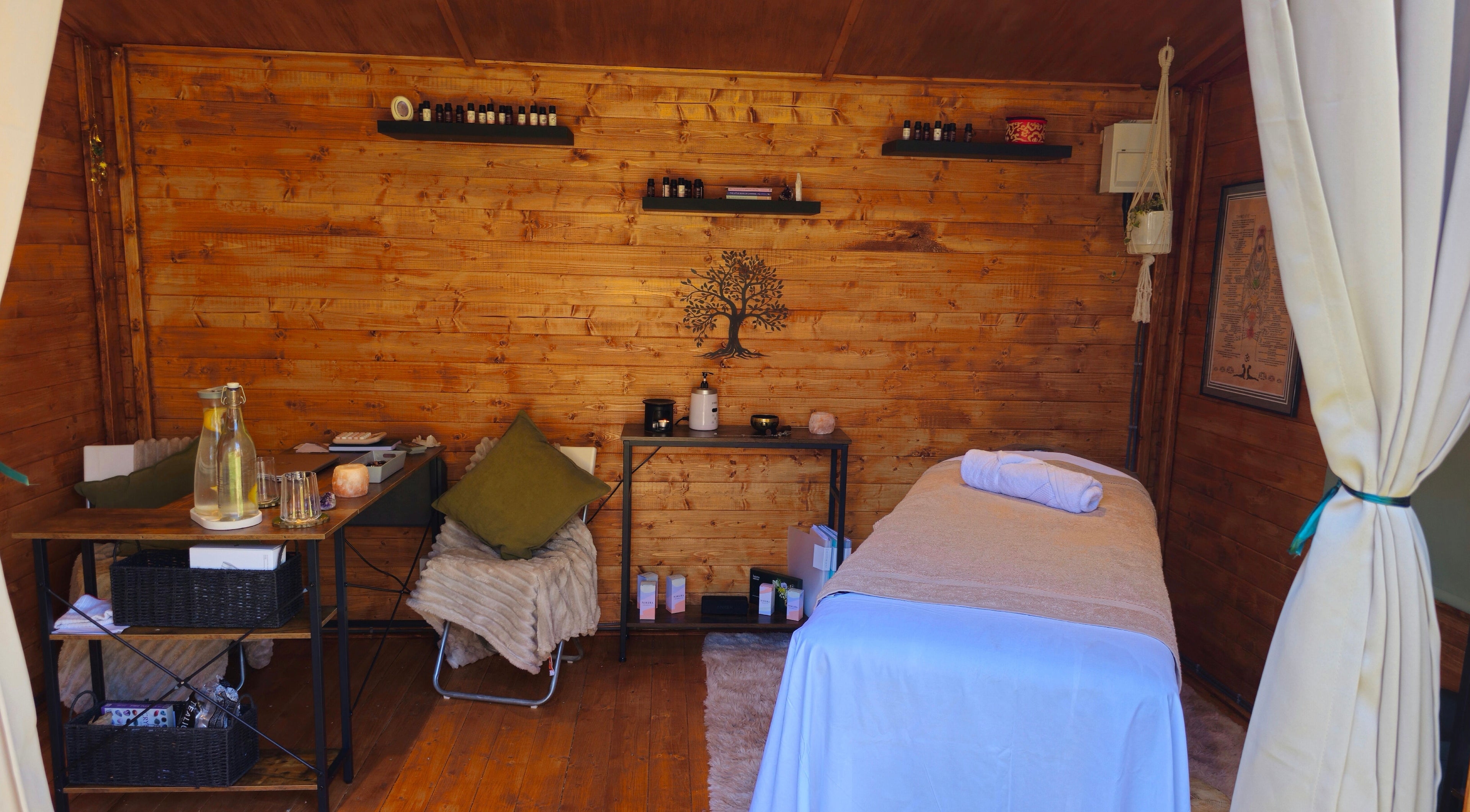 Relaxing massage room at Saltwoods Healing & Massage, Herne Bay, England, GB, featuring a cozy wooden interior.