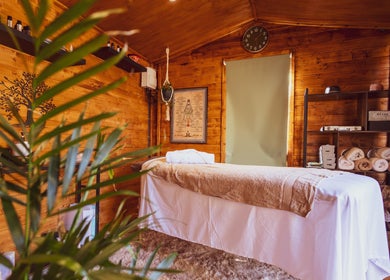 Cozy massage room at Saltwoods Healing & Massage, Herne Bay, England, GB with wooden walls and a treatment bed.