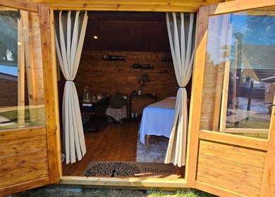 Inviting therapy room at Saltwoods Healing & Massage in Herne Bay, England, GB, featuring cozy wood interiors.