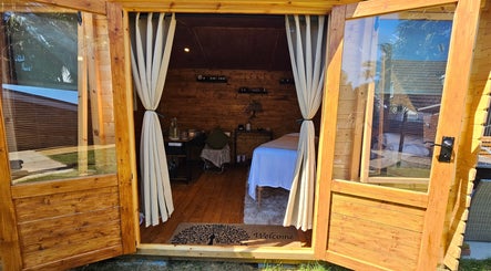 Inviting therapy room at Saltwoods Healing & Massage in Herne Bay, England, GB, featuring cozy wood interiors.