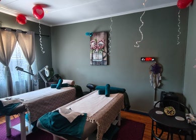 Relaxing massage room at The Masked Spa Mobile in De Kelders, Western Cape, ZA with twin tables and serene decor.
