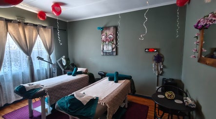 Relaxing massage room at The Masked Spa Mobile in De Kelders, Western Cape, ZA with twin tables and serene decor.