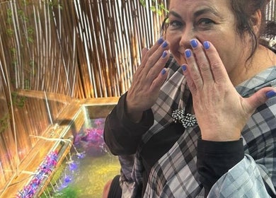 Woman enjoying treatment at The Masked Spa Mobile, De Kelders, Western Cape, ZA, showcasing vibrant décor.