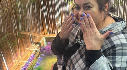 Woman enjoying treatment at The Masked Spa Mobile, De Kelders, Western Cape, ZA, showcasing vibrant décor.
