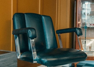 Vintage barber chair at Loveday's Barber Shop in Sheffield, England, GB, showcasing classic style and comfort.