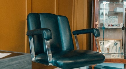 Vintage barber chair at Loveday's Barber Shop in Sheffield, England, GB, showcasing classic style and comfort.