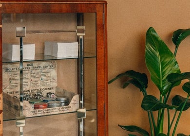 Classic wooden display cabinet at Loveday's Barber Shop, Sheffield, England, GB, showcasing grooming products.
