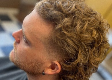 Stylish curly haircut at Loveday's Barber Shop, Sheffield, England, GB. Perfect blend of modern style and classic barbering.