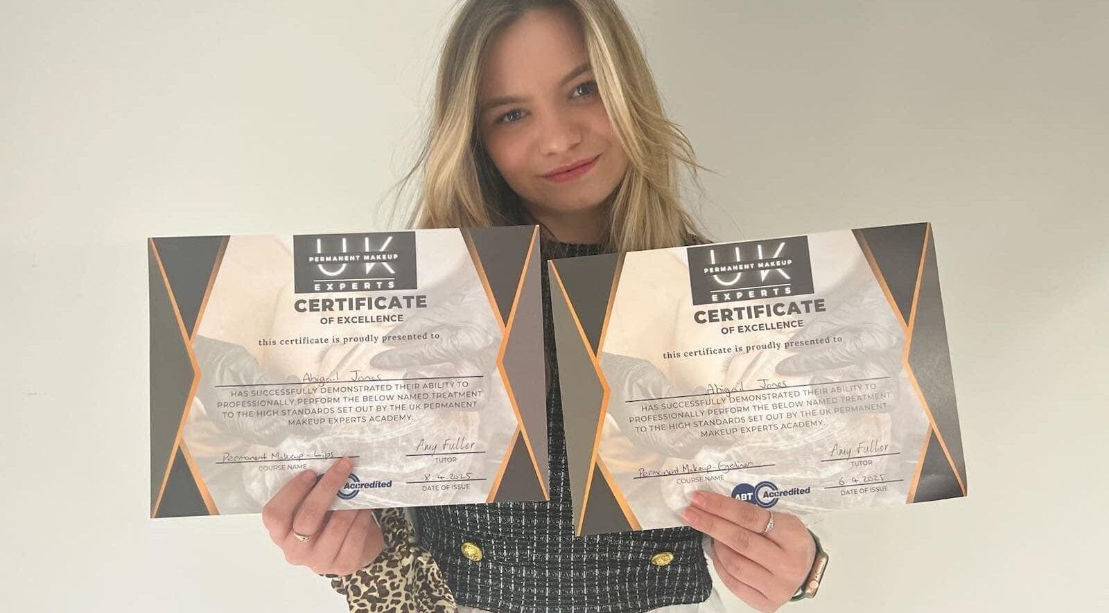 Professional holding certificates at elegance permanent makeup in Kirkby In Ashfield, England, GB showcasing excellence.