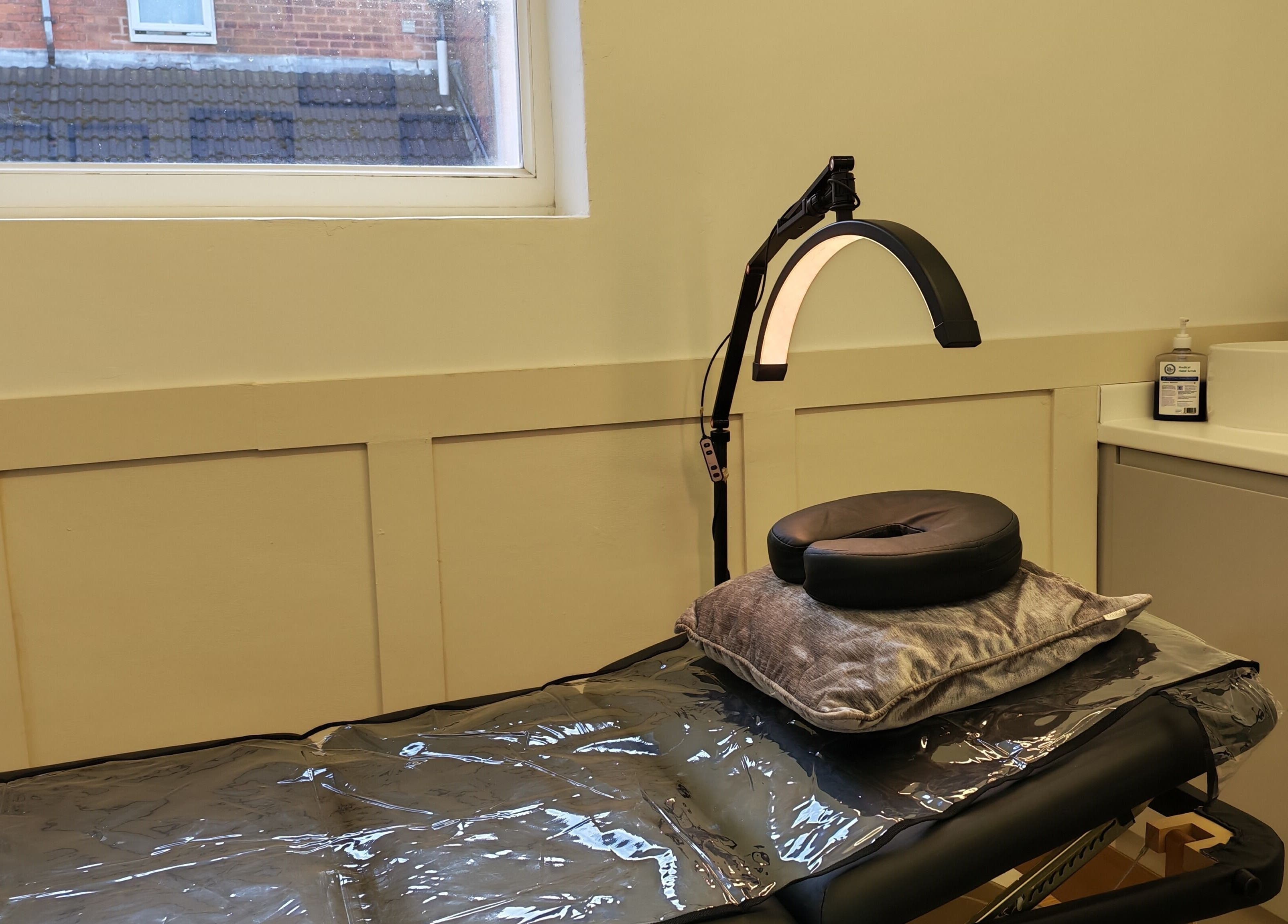 Cozy treatment room at Elegance Permanent Makeup, Kirkby In Ashfield, England, GB with a reclining chair and equipment.