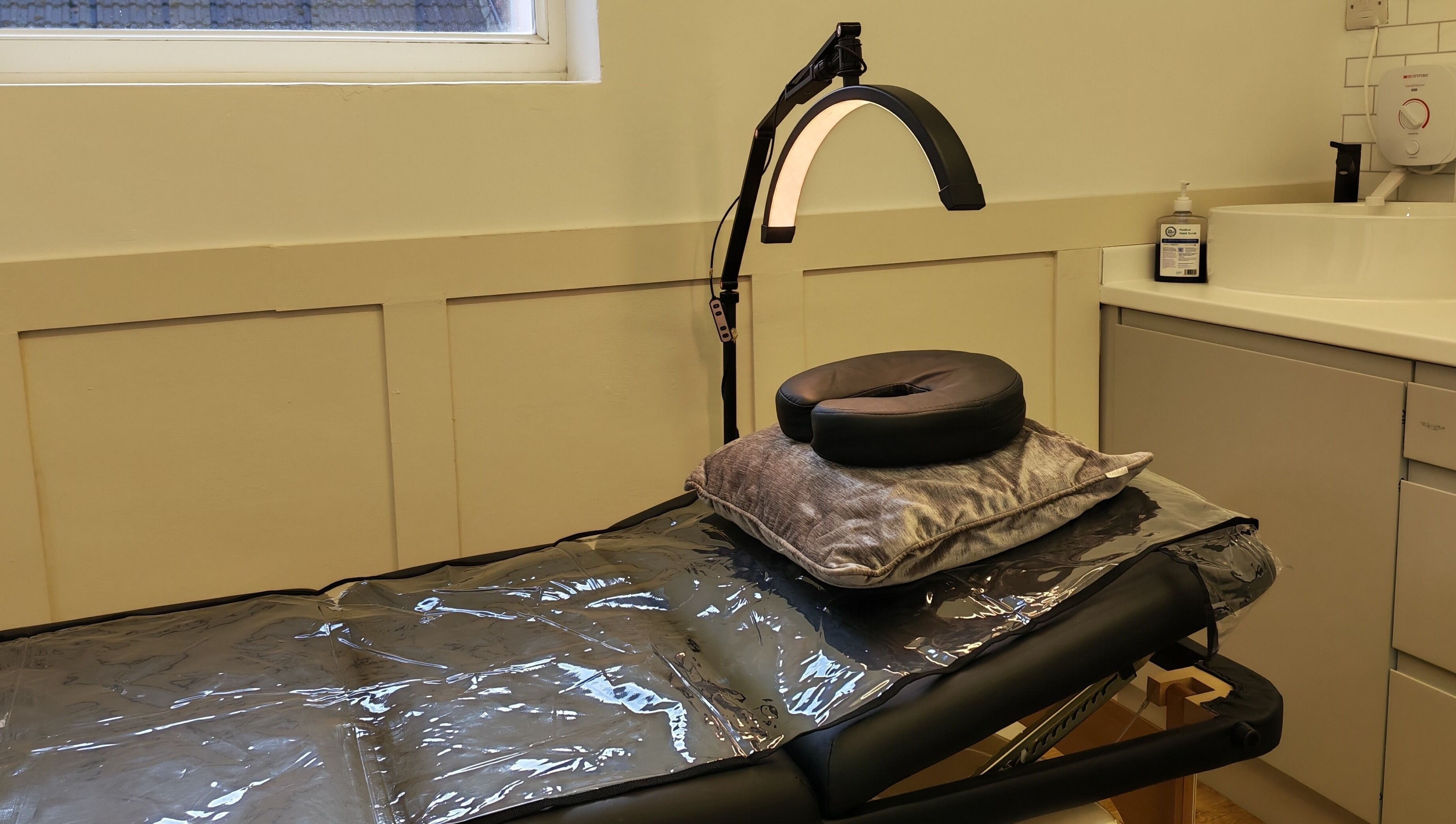 Comfortable treatment bed at Elegance Permanent Makeup, Kirkby In Ashfield, England, GB with adjustable lighting.