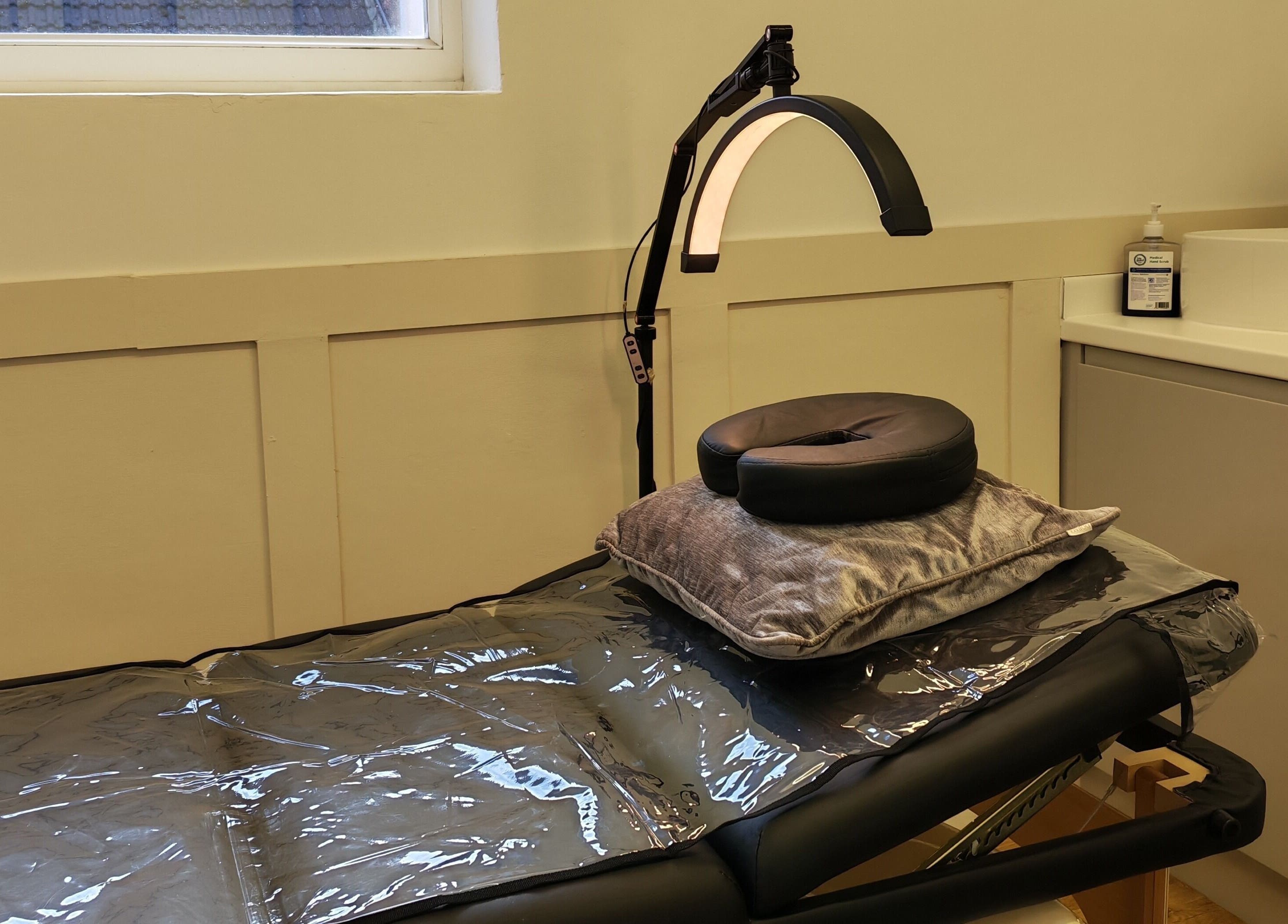 Comfortable treatment bed at Elegance Permanent Makeup, Kirkby In Ashfield, England, GB with adjustable lighting.