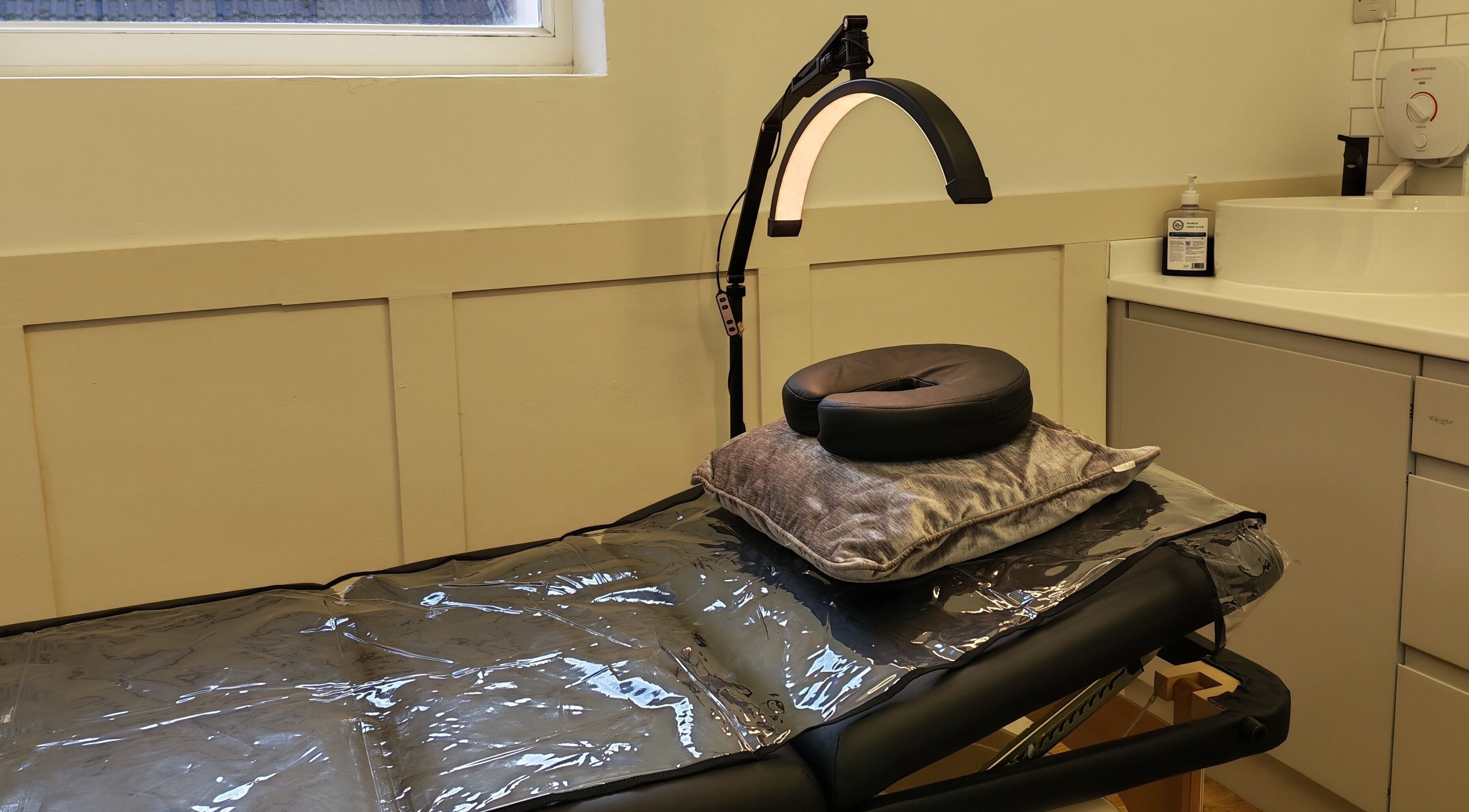 Comfortable treatment bed at Elegance Permanent Makeup, Kirkby In Ashfield, England, GB with adjustable lighting.
