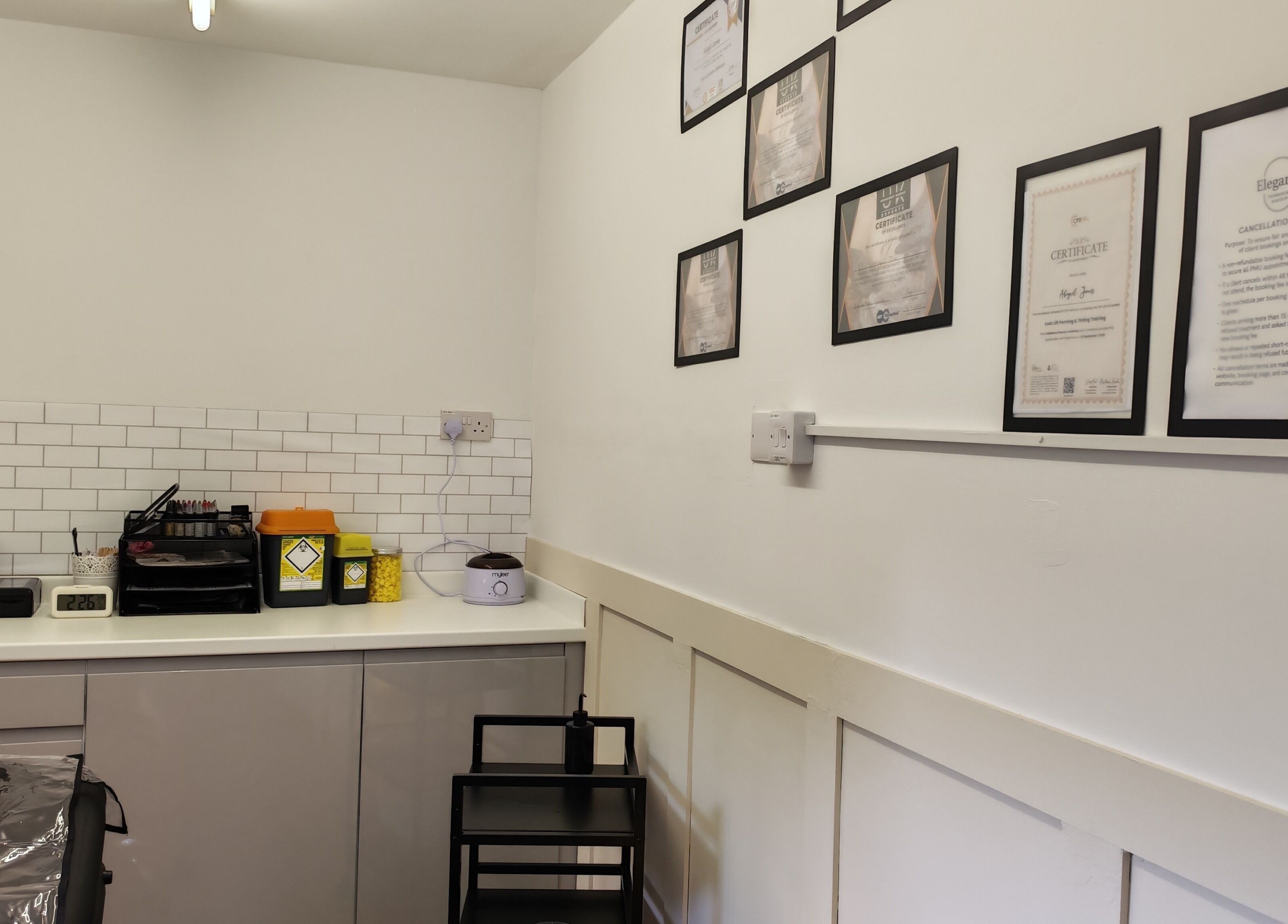 Elegance Permanent Makeup's professional setup in Kirkby In Ashfield, England, showcasing certificates on the wall.