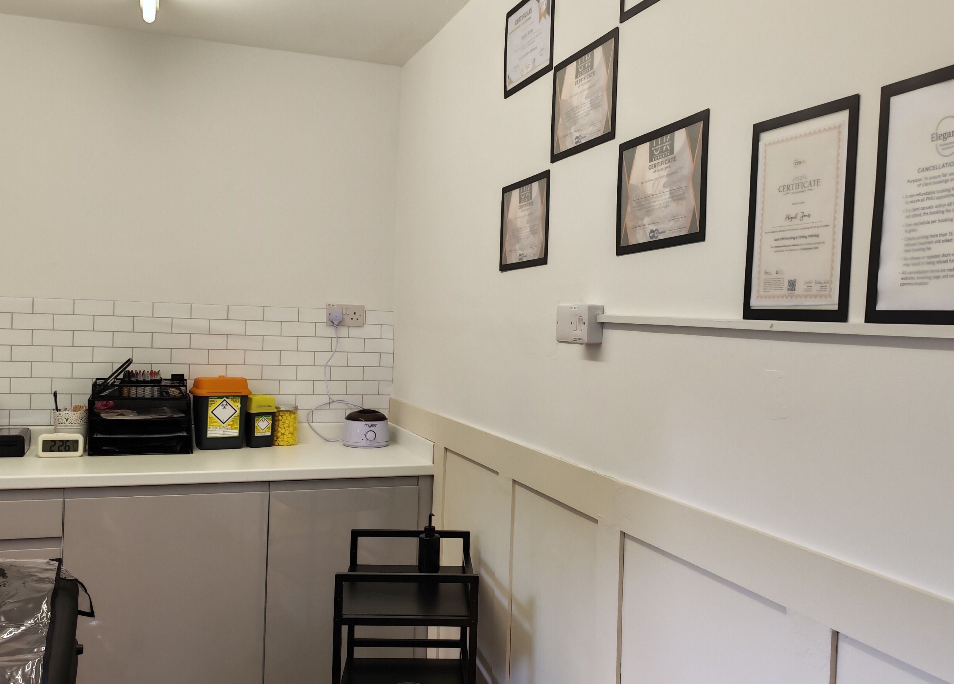 Elegance Permanent Makeup's professional setup in Kirkby In Ashfield, England, showcasing certificates on the wall.