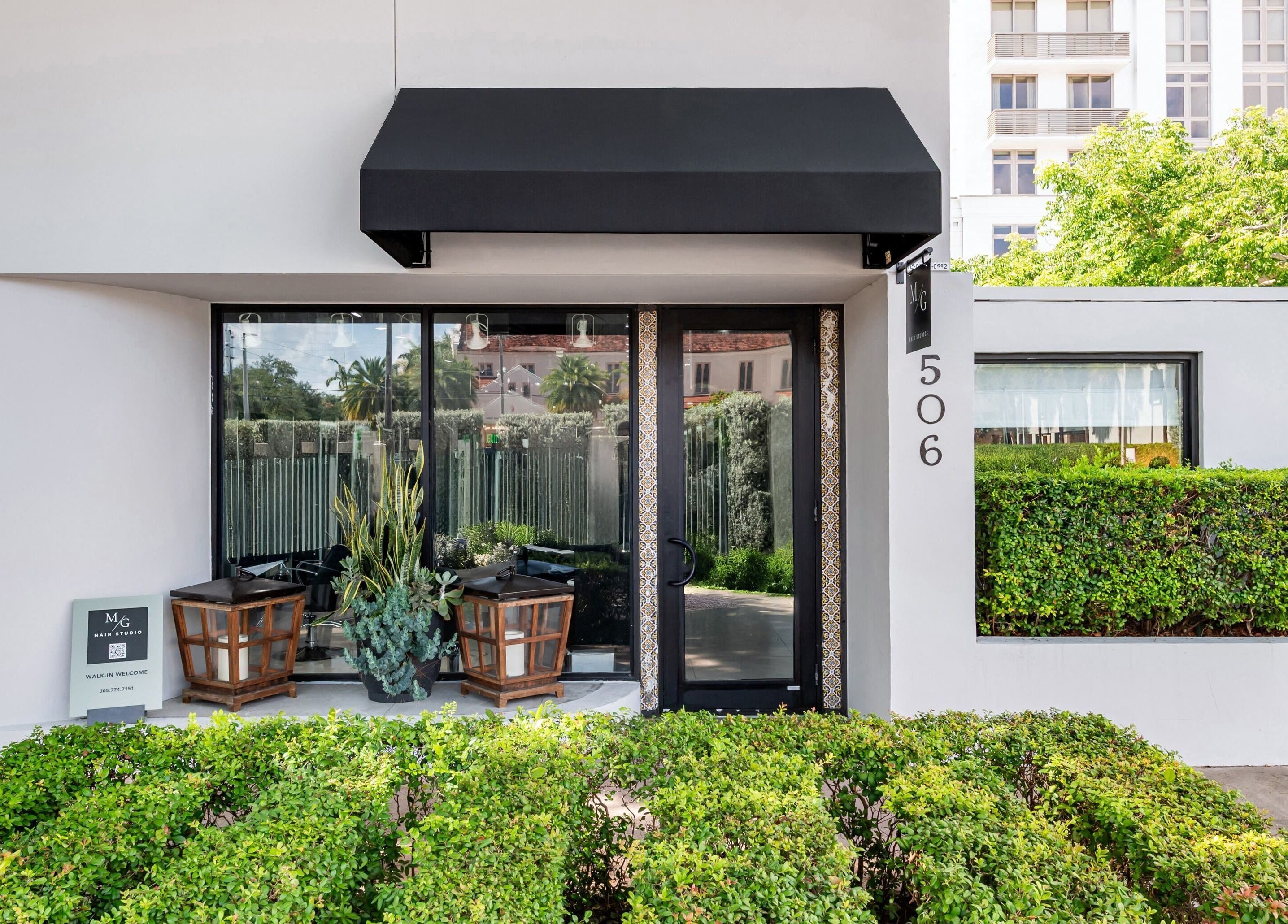 Entrance of MG Hair Studios in Coral Gables, Florida, US with a modern, inviting facade.