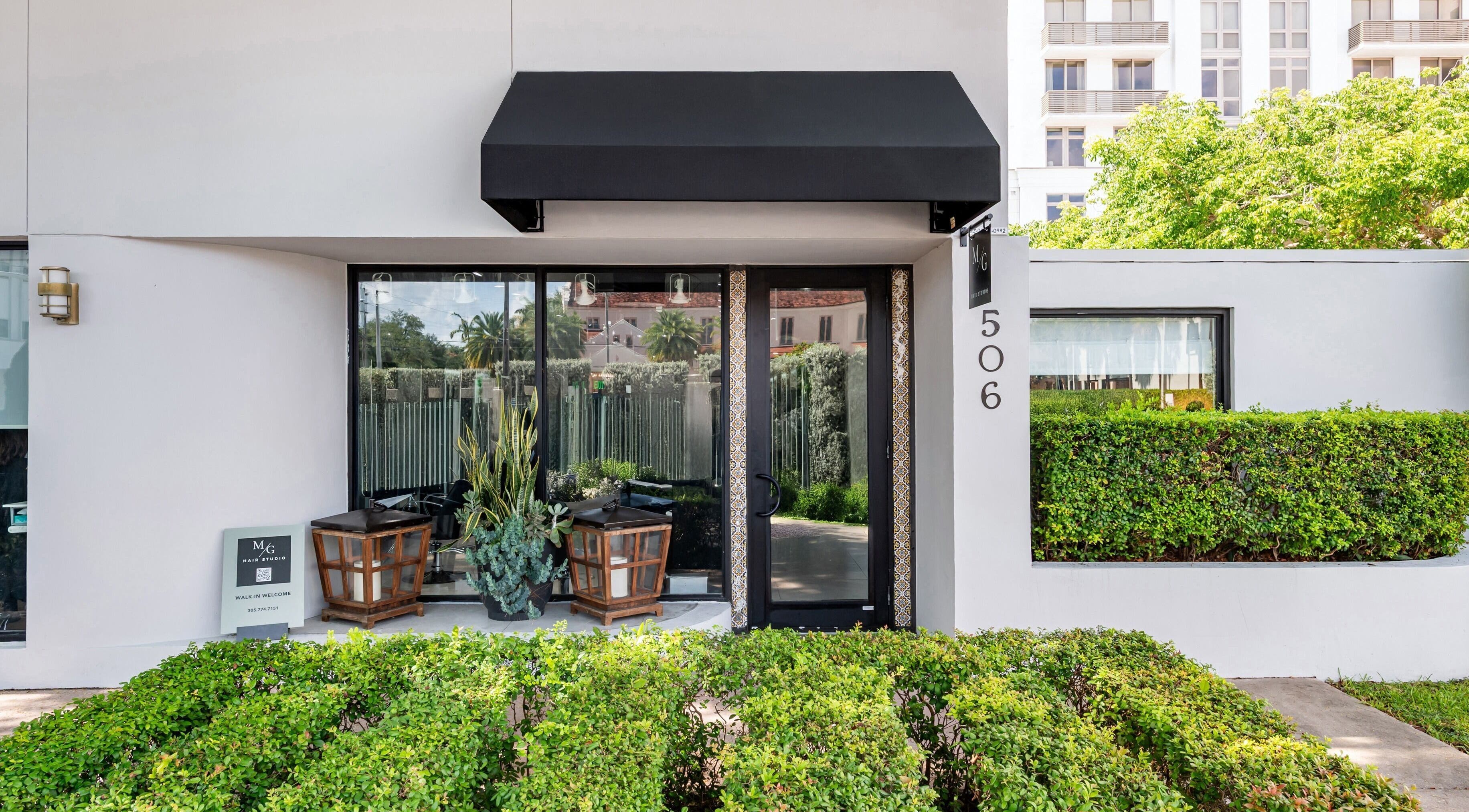 Entrance of MG Hair Studios in Coral Gables, Florida, US with a modern, inviting facade.