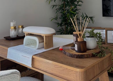 Elegant spa desk setup at AmiRoseBeauté, Barrington, England, GB, featuring natural decor and wellness items.