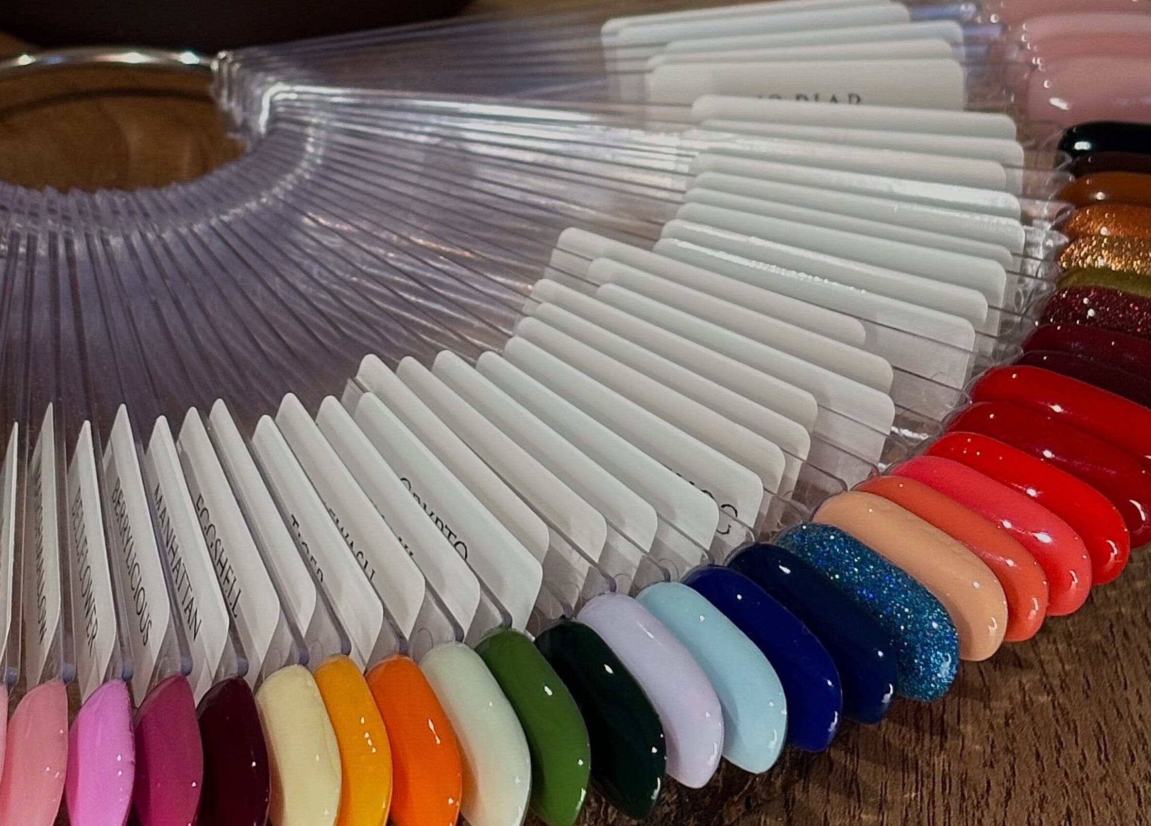 Colorful nail polish swatches at AmiRoseBeauté in Barrington, England, GB, showcasing vibrant manicure options.