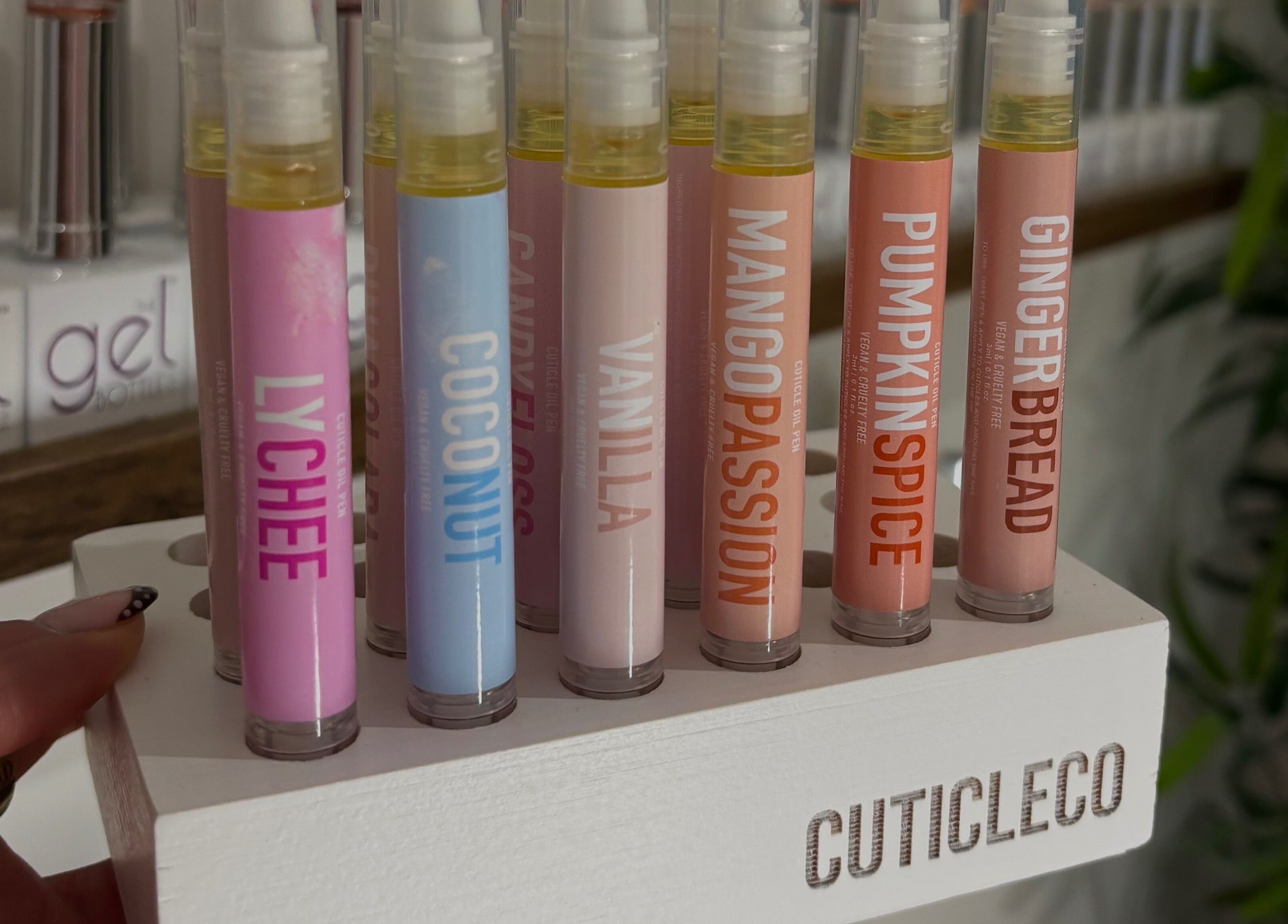 Variety of cuticle oil pens on display at AmiRoseBeauté, Barrington, England, GB.