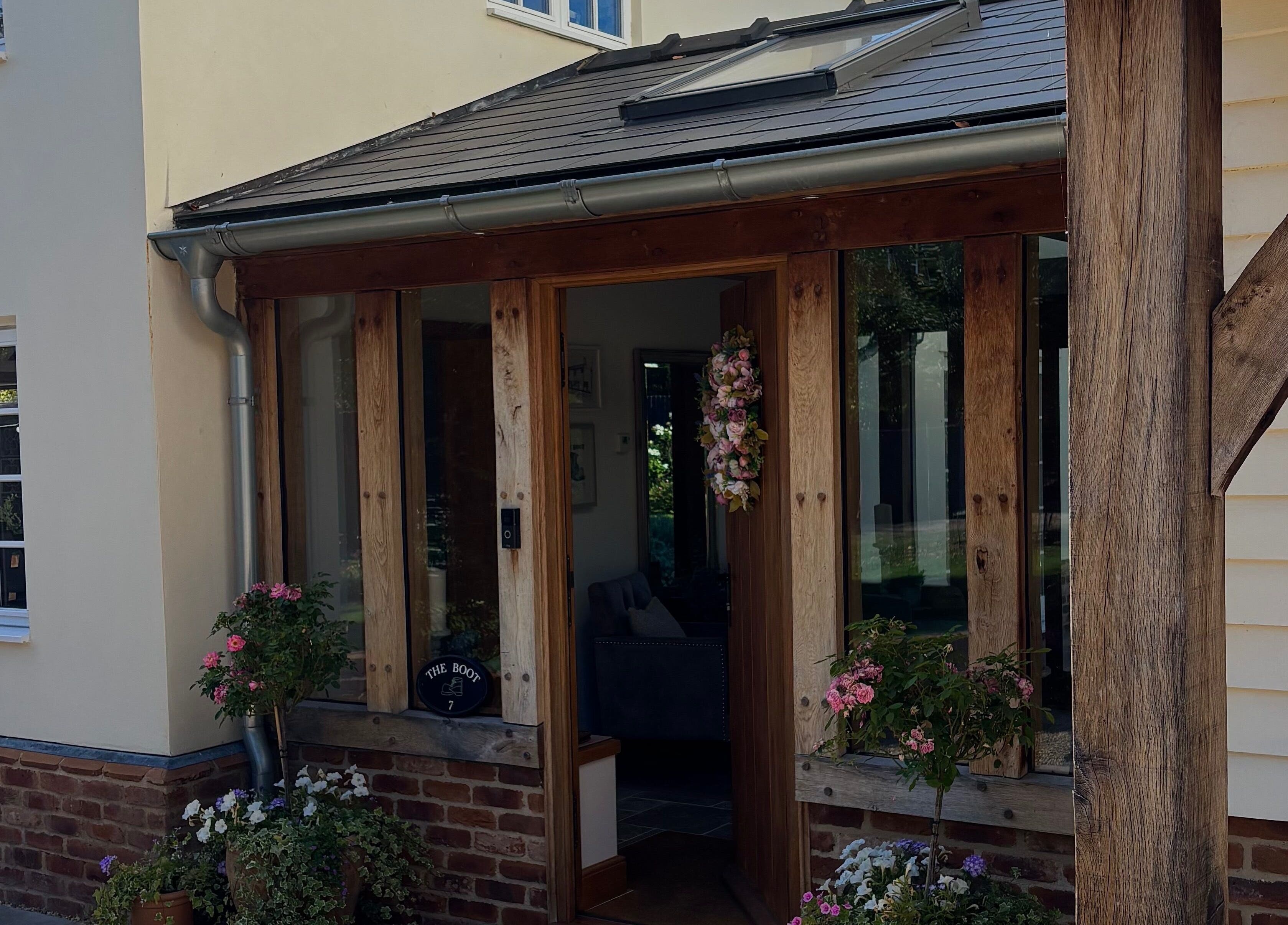 Charming entry at AmiRoseBeauté, Barrington, England, GB, featuring rustic wood and floral decor.