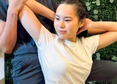 Woman enjoying a stretch at Thai massage wellness in Las Vegas, Nevada, US.