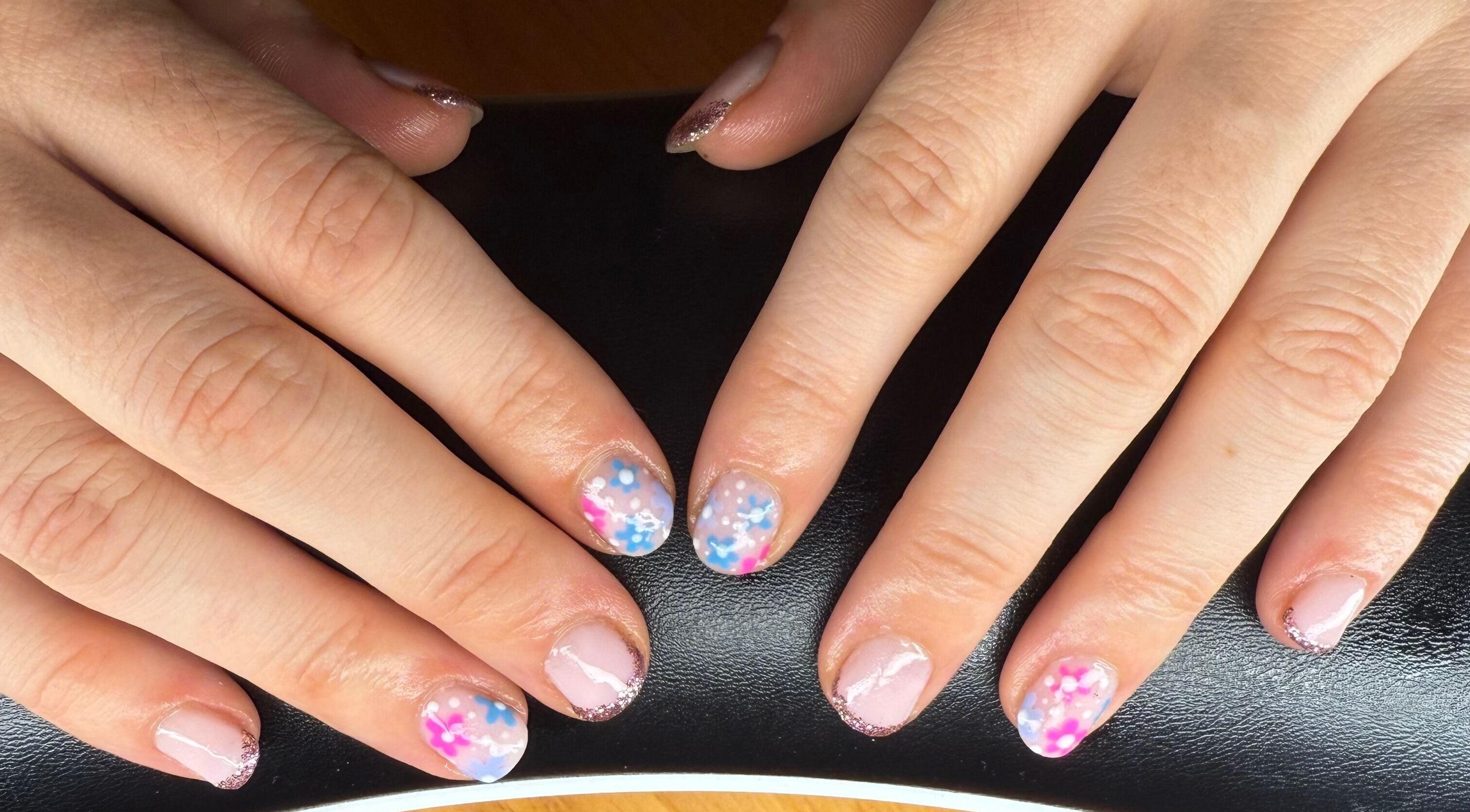 Colorful floral nail art at Mindful Beauty, Lochmaben, Scotland, GB. Enhance your style with unique designs.