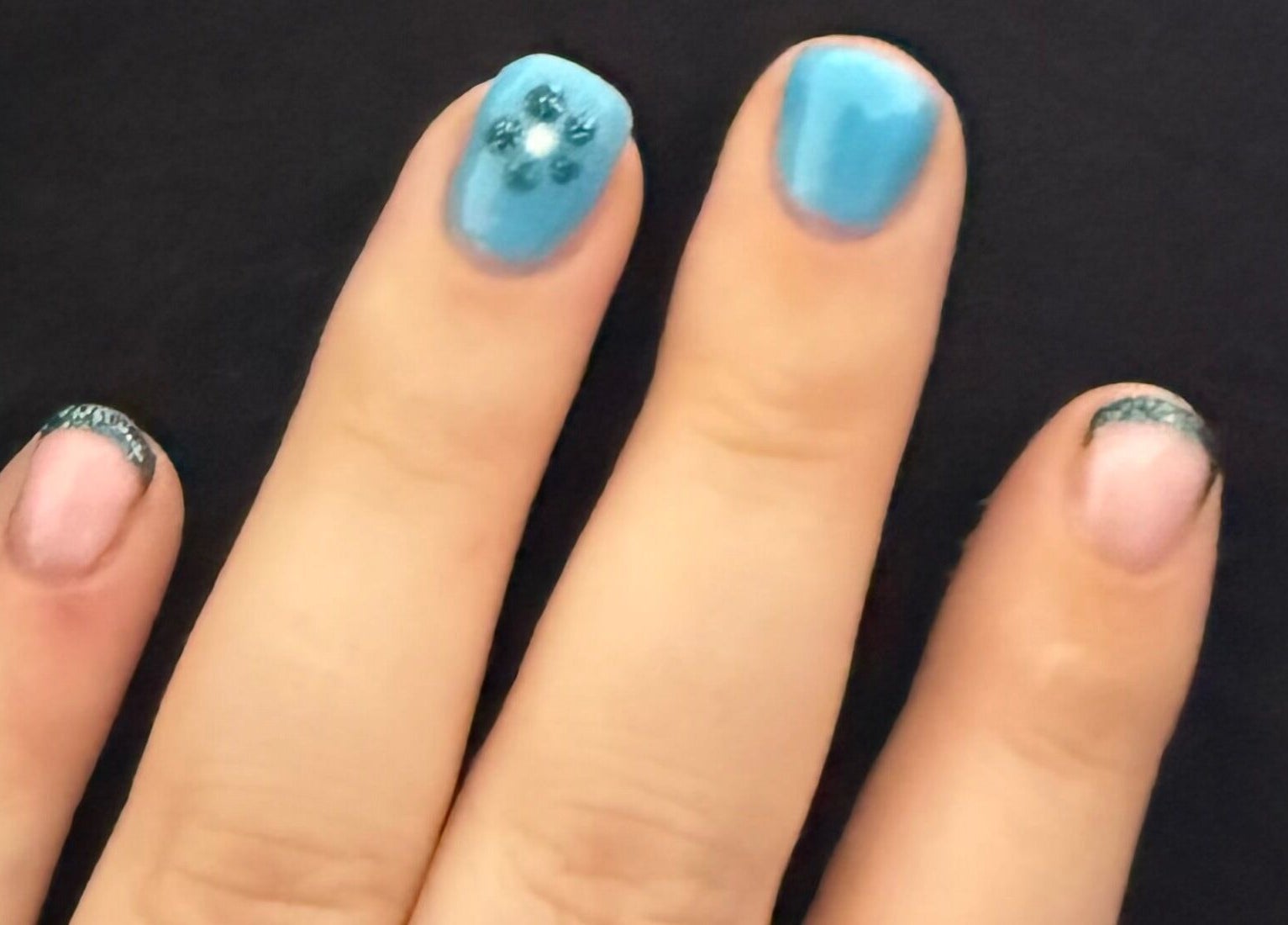 Stylish manicure at Mindful Beauty in Lochmaben, Scotland, GB featuring blue and pink nail art.