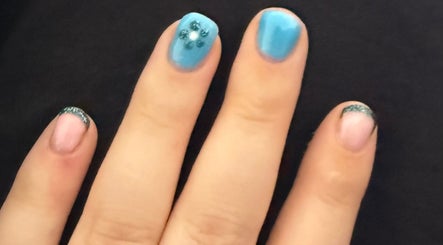 Stylish manicure at Mindful Beauty in Lochmaben, Scotland, GB featuring blue and pink nail art.