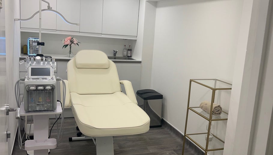 Elegant treatment room at Niymimi Aesthetics, London, England, GB, featuring a plush chair and modern equipment.