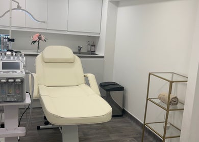 Elegant treatment room at Niymimi Aesthetics, London, England, GB, featuring a plush chair and modern equipment.