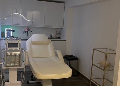 Luxurious treatment room at Niymimi Aesthetics in London, England, GB, featuring a modern spa chair and equipment.
