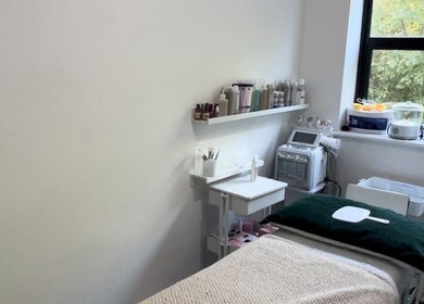 Relaxing spa room at MYAB London, located in Stanmore, England, GB, with treatment table and skincare products.