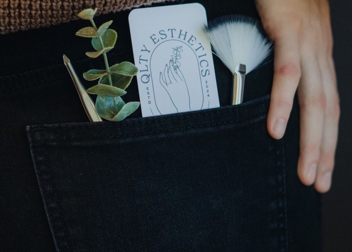 QLTY ESTHETICS card, brushes, and plant in pocket at Nanaimo, British Columbia, CA.
