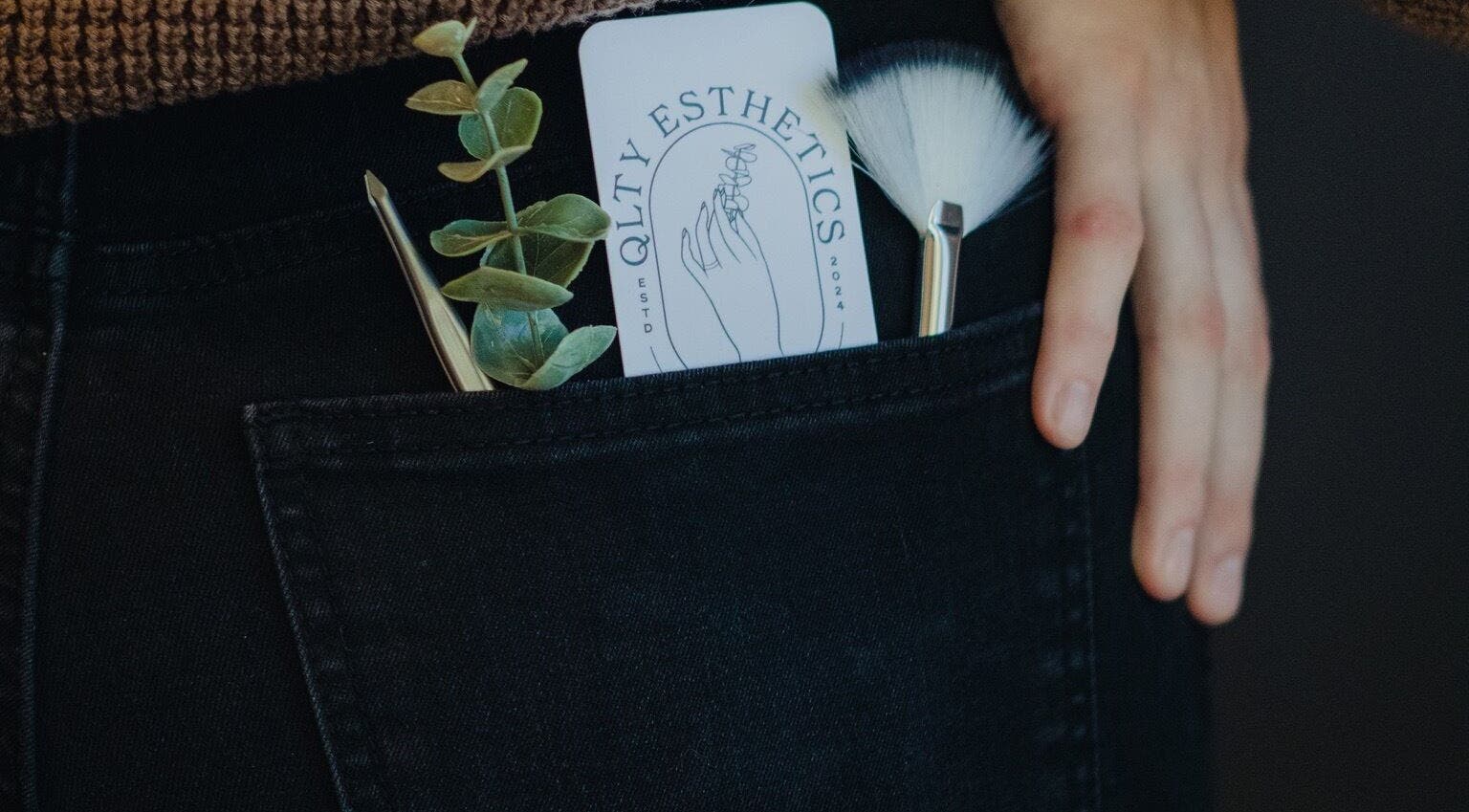 QLTY ESTHETICS card, brushes, and plant in pocket at Nanaimo, British Columbia, CA.