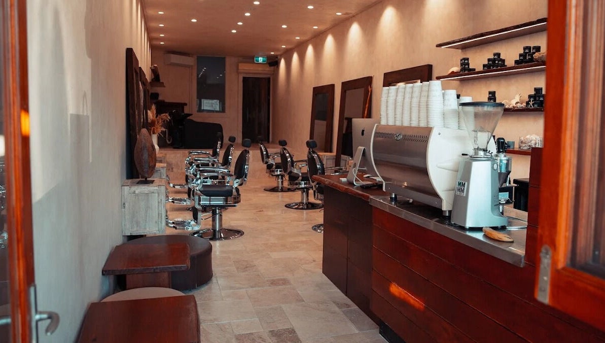 Interior of Waves Barbershop in West End, Queensland, AU, showcasing modern chairs and stylish decor.