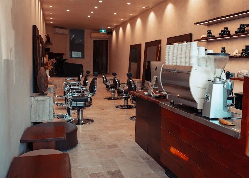 Interior of Waves Barbershop in West End, Queensland, AU, showcasing modern chairs and stylish decor.
