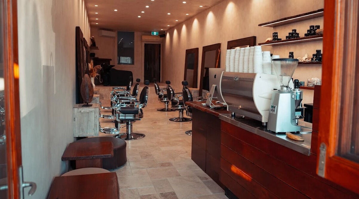 Interior of Waves Barbershop in West End, Queensland, AU, showcasing modern chairs and stylish decor.