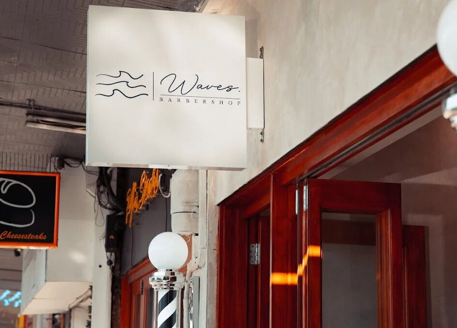 Exterior of Waves Barbershop in West End, Queensland, AU showcasing its distinctive signage.