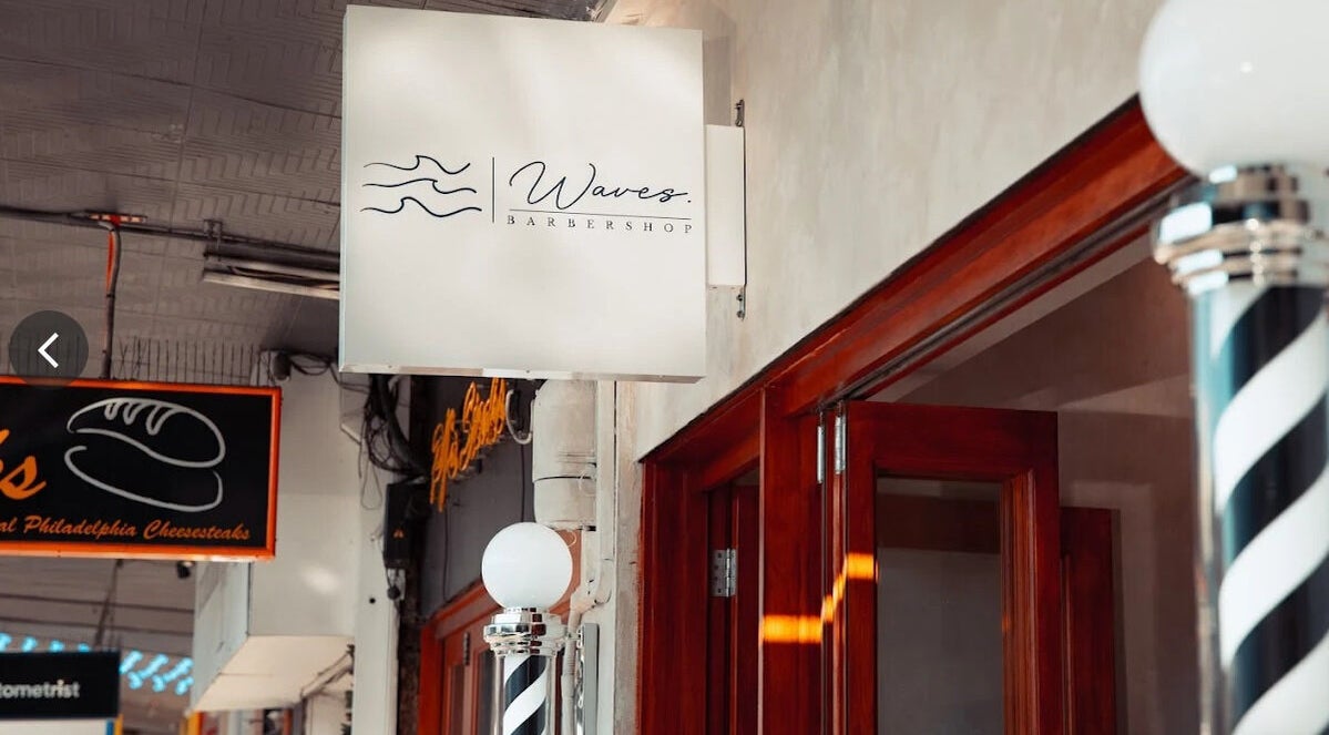 Exterior of Waves Barbershop in West End, Queensland, AU showcasing its distinctive signage.