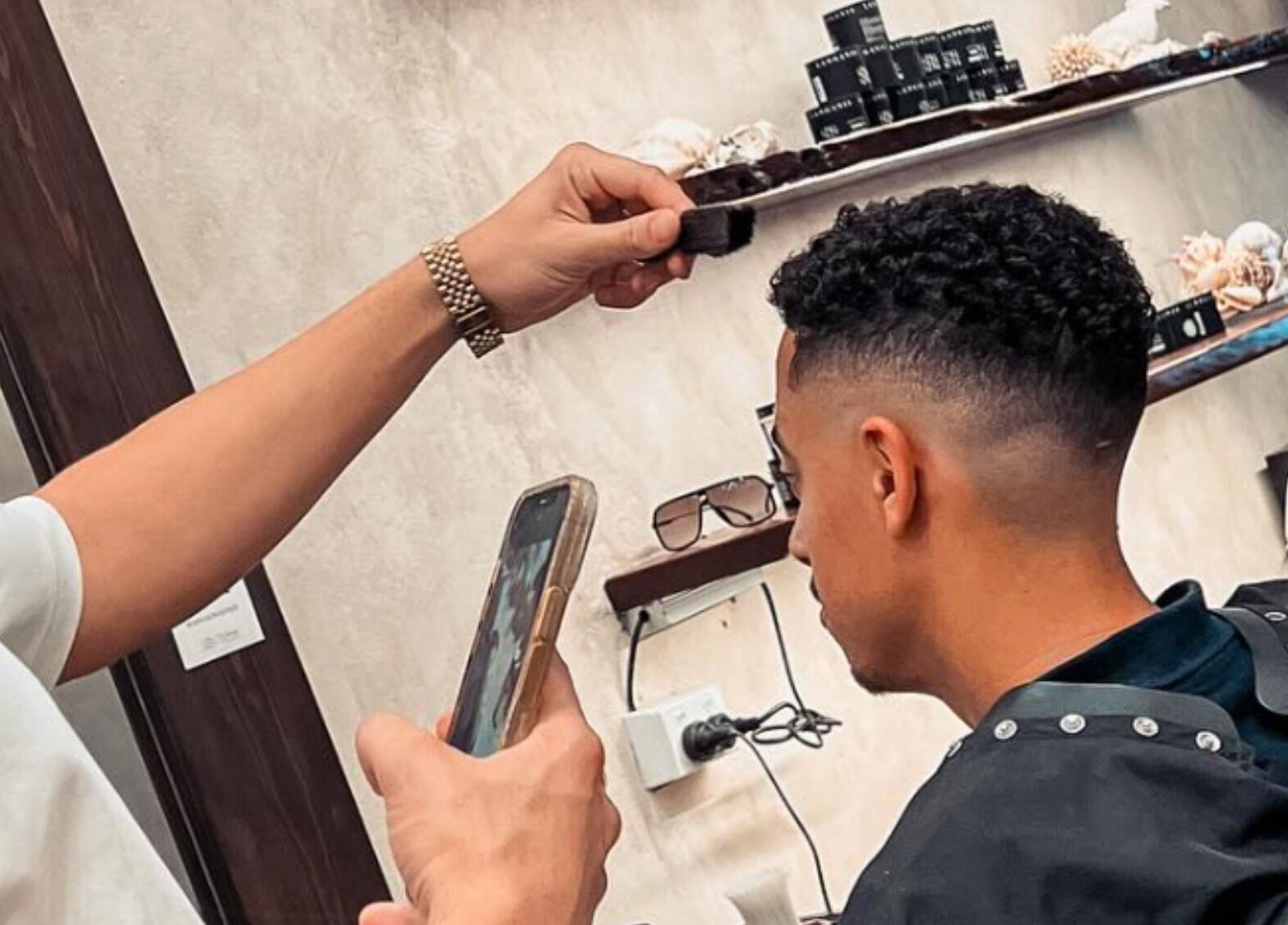 Barber crafting modern hairstyle at Waves Barbershop, West End, Queensland, AU.