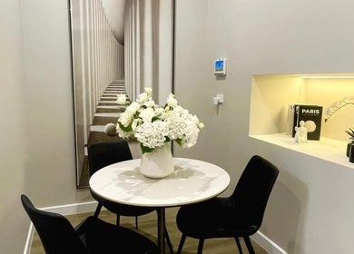 Elegant seating area at The Contour Method in Melbourne, Victoria, AU, featuring chic decor and floral arrangement.