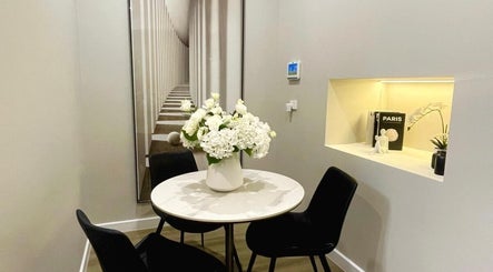 Elegant seating area at The Contour Method in Melbourne, Victoria, AU, featuring chic decor and floral arrangement.