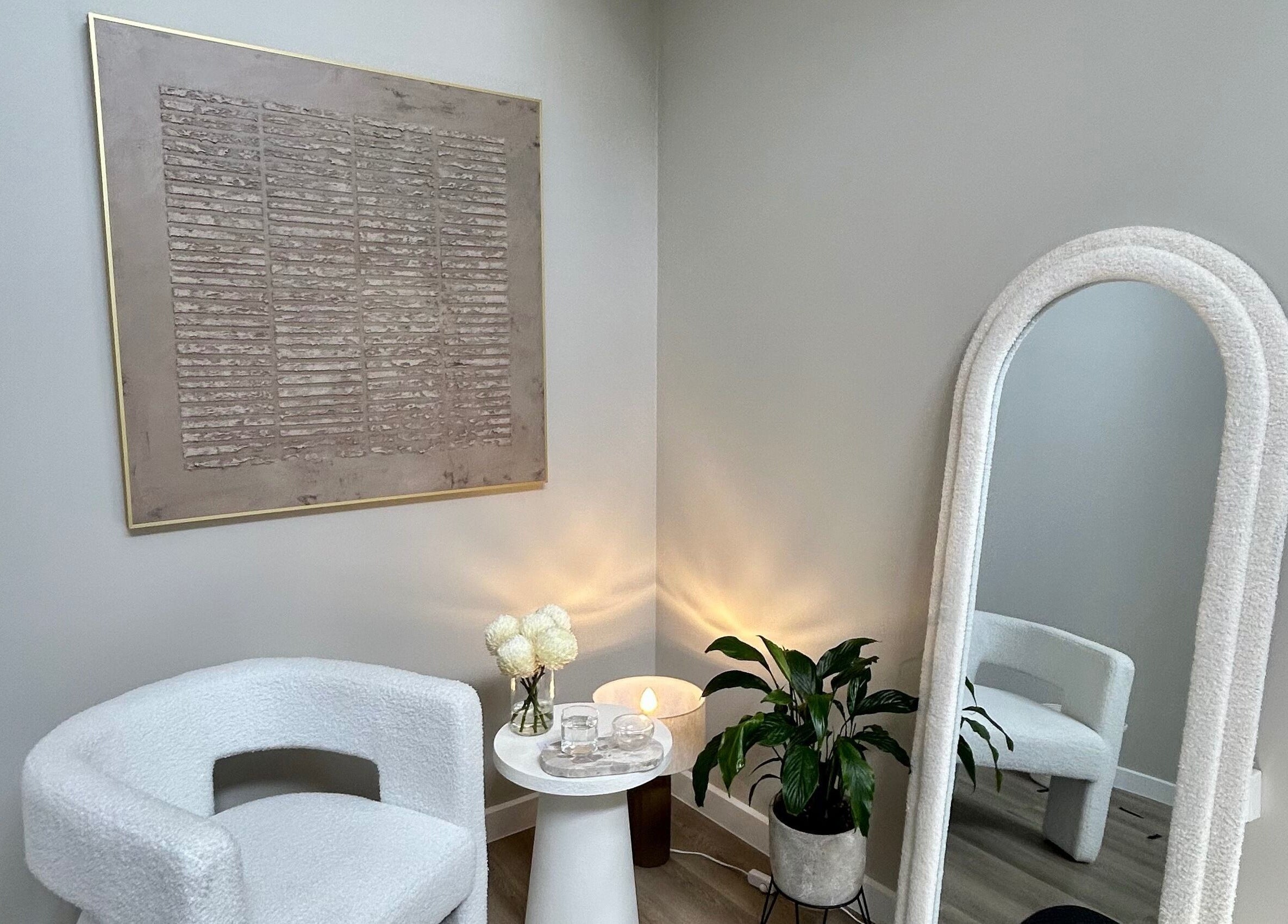Relaxing corner at The Contour Method in Melbourne, Victoria, AU with elegant chair and decorative mirror.