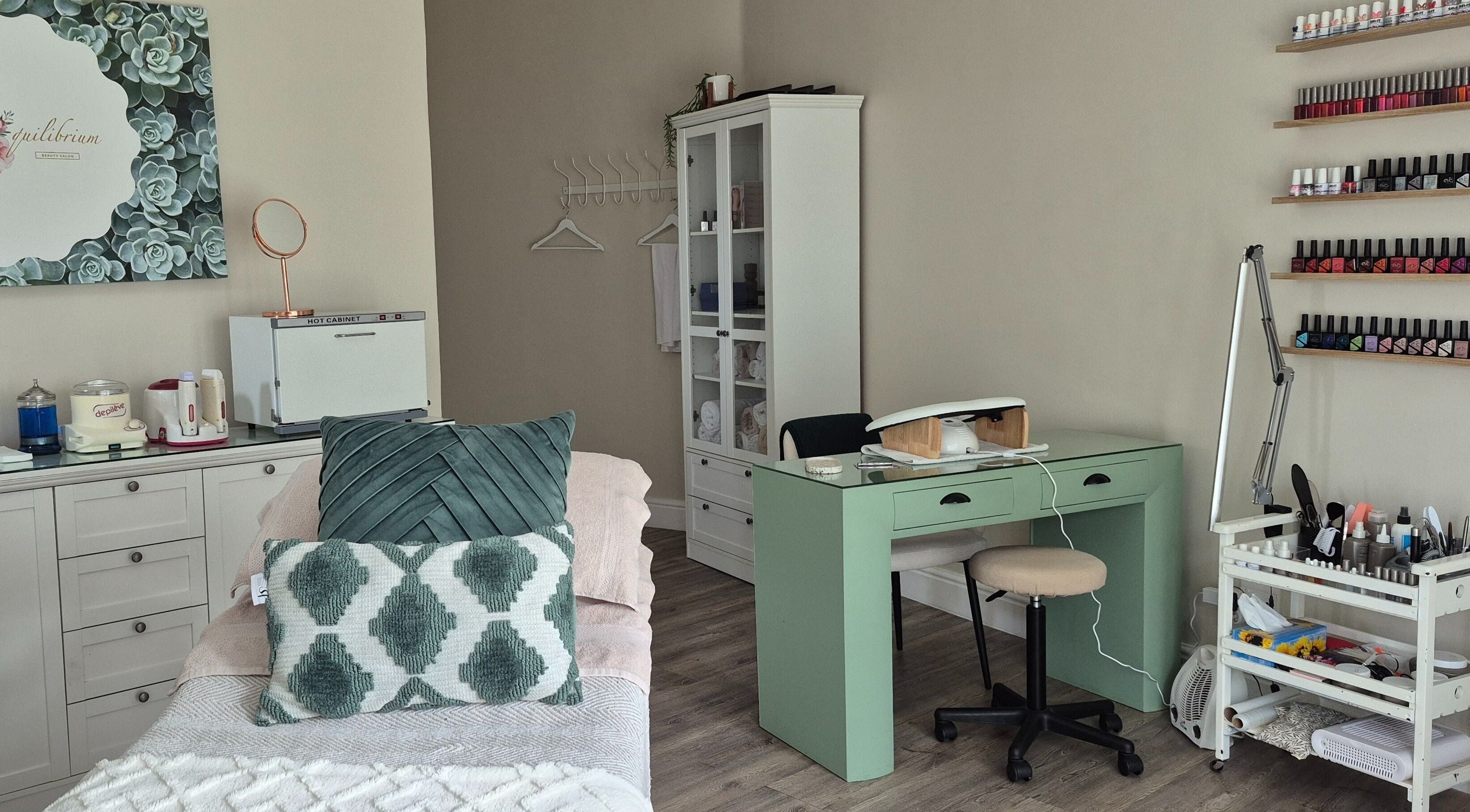 Stylish treatment room at Equilibrium Beauty Salon, Cape Town, Western Cape, ZA, with manicure setup and skincare products.