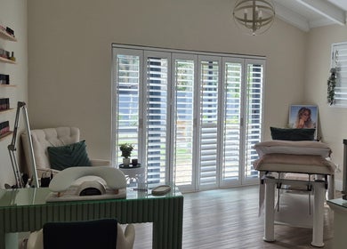 Bright treatment room at Equilibrium Beauty Salon, Cape Town, Western Cape, ZA with comfy chair and nail polishes.