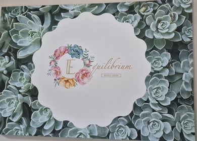 Equilibrium Beauty Salon logo with floral design in Cape Town, Western Cape, ZA, on a succulent background.