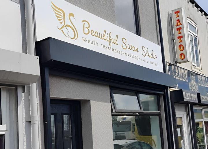 Exterior view of Beautiful Swan Studio sign, Swinton, England, GB showcasing beauty and wellness services.