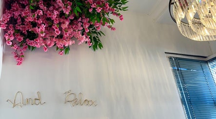 Elegant chandelier and pink blossoms at Chloe Louise Beauty, Lossiemouth, Scotland, GB, enhancing relaxation.